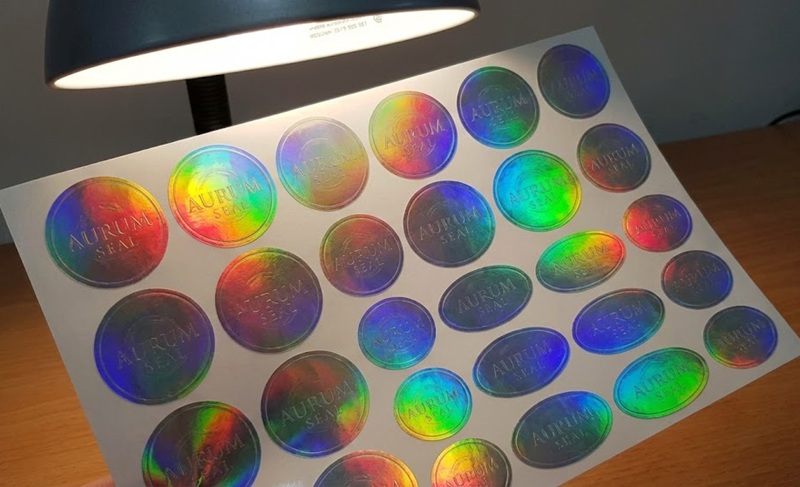 Các mẫu tem bảo hành hologram 7 màu hình tròn và elip.